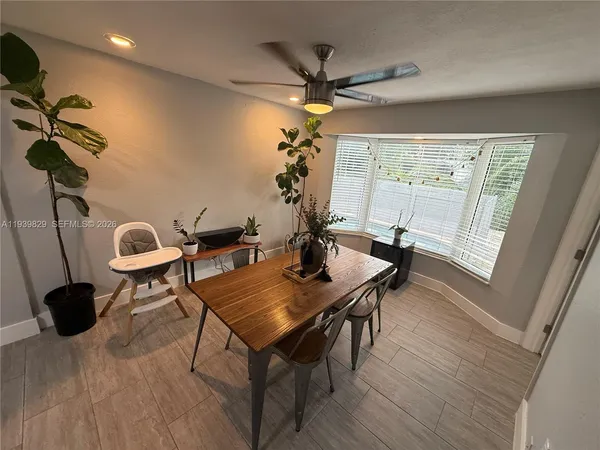a view of a room with wooden floor and a floor to ceiling window