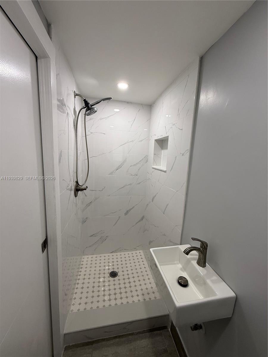 5280 Southwest 92nd Terrace Cooper City, FL 33328 - Photo 26 of 50 a bathroom with a sink and shower