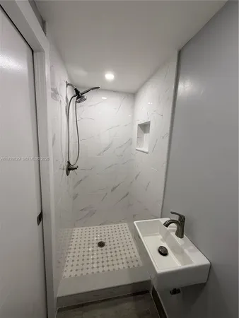 a spacious bathroom with a granite countertop sink toilet and shower
