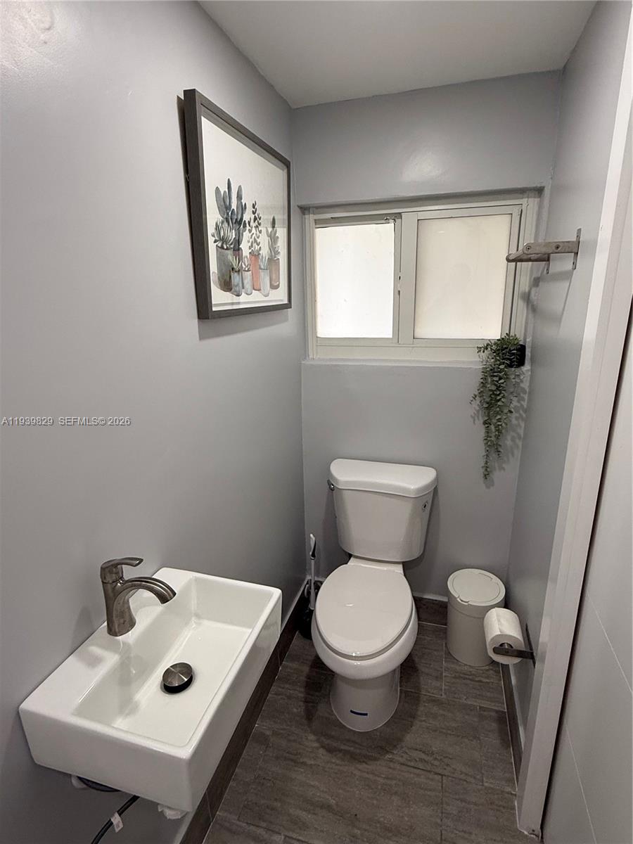 5280 Southwest 92nd Terrace Cooper City, FL 33328 - Photo 28 of 50 a bathroom with a toilet sink and mirror