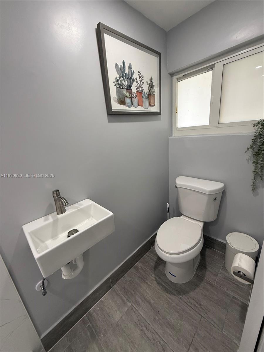 5280 Southwest 92nd Terrace Cooper City, FL 33328 - Photo 29 of 50 a bathroom with a toilet a sink and mirror