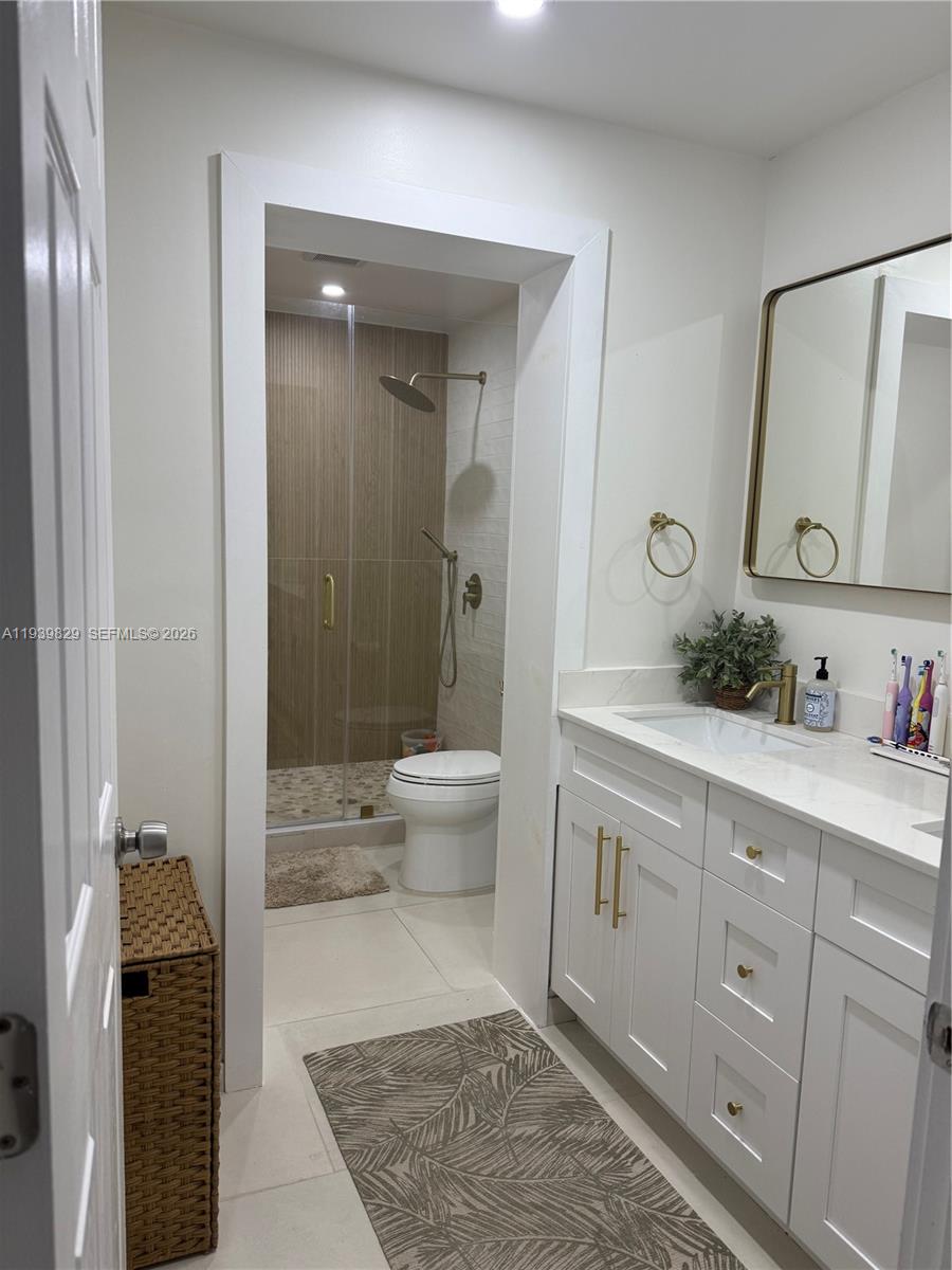 5280 Southwest 92nd Terrace Cooper City, FL 33328 - Photo 30 of 50 a spacious bathroom with a granite countertop sink toilet and shower