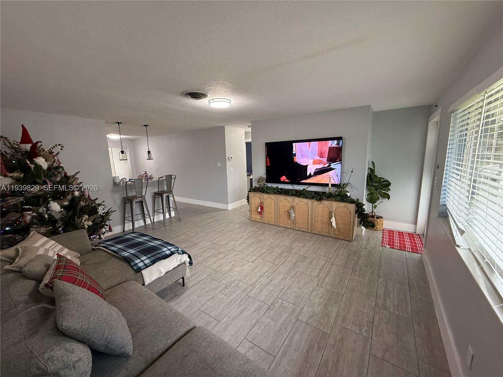 5280 Southwest 92nd Terrace Cooper City, FL 33328 - Photo 43 of 50 a living room with furniture and a flat screen tv