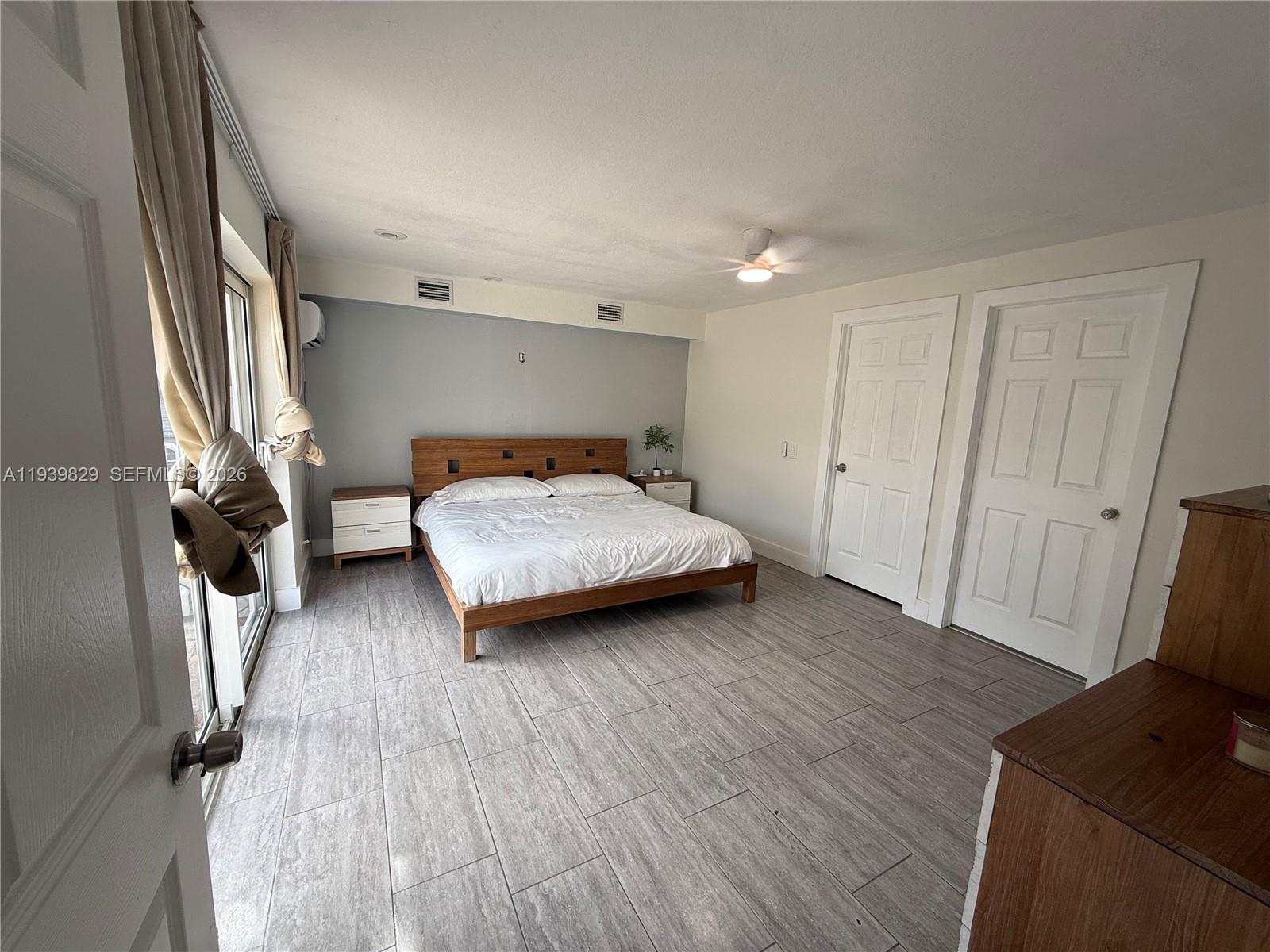 5280 Southwest 92nd Terrace Cooper City, FL 33328 - Photo 45 of 50 a bedroom with a bed and a flat tv screen on the dresser