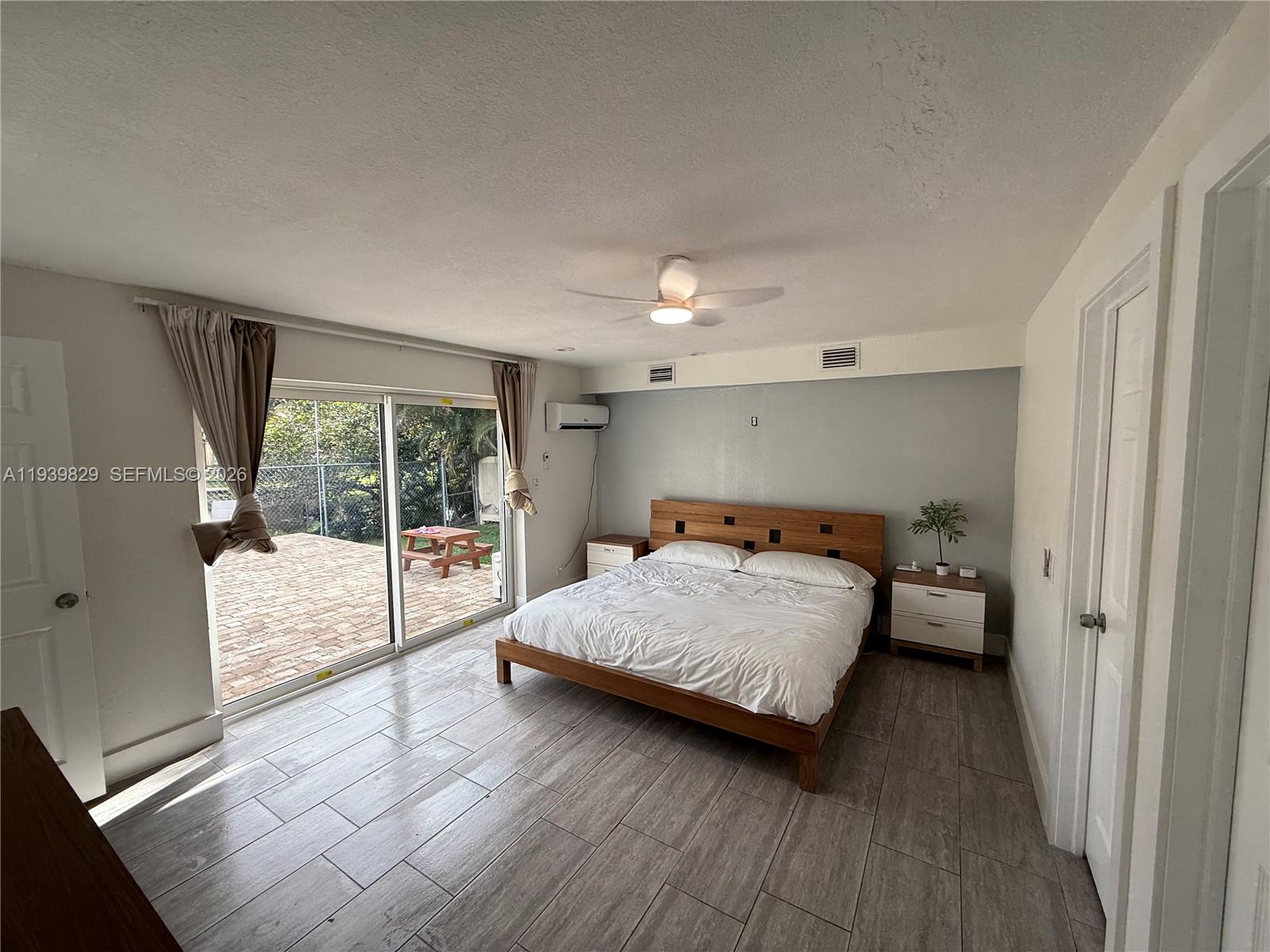 5280 Southwest 92nd Terrace Cooper City, FL 33328 - Photo 46 of 50 a bedroom with a bed and wooden floor