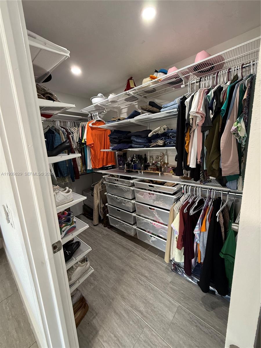 5280 Southwest 92nd Terrace Cooper City, FL 33328 - Photo 47 of 50 a view of walk in closet with clothes and shoes