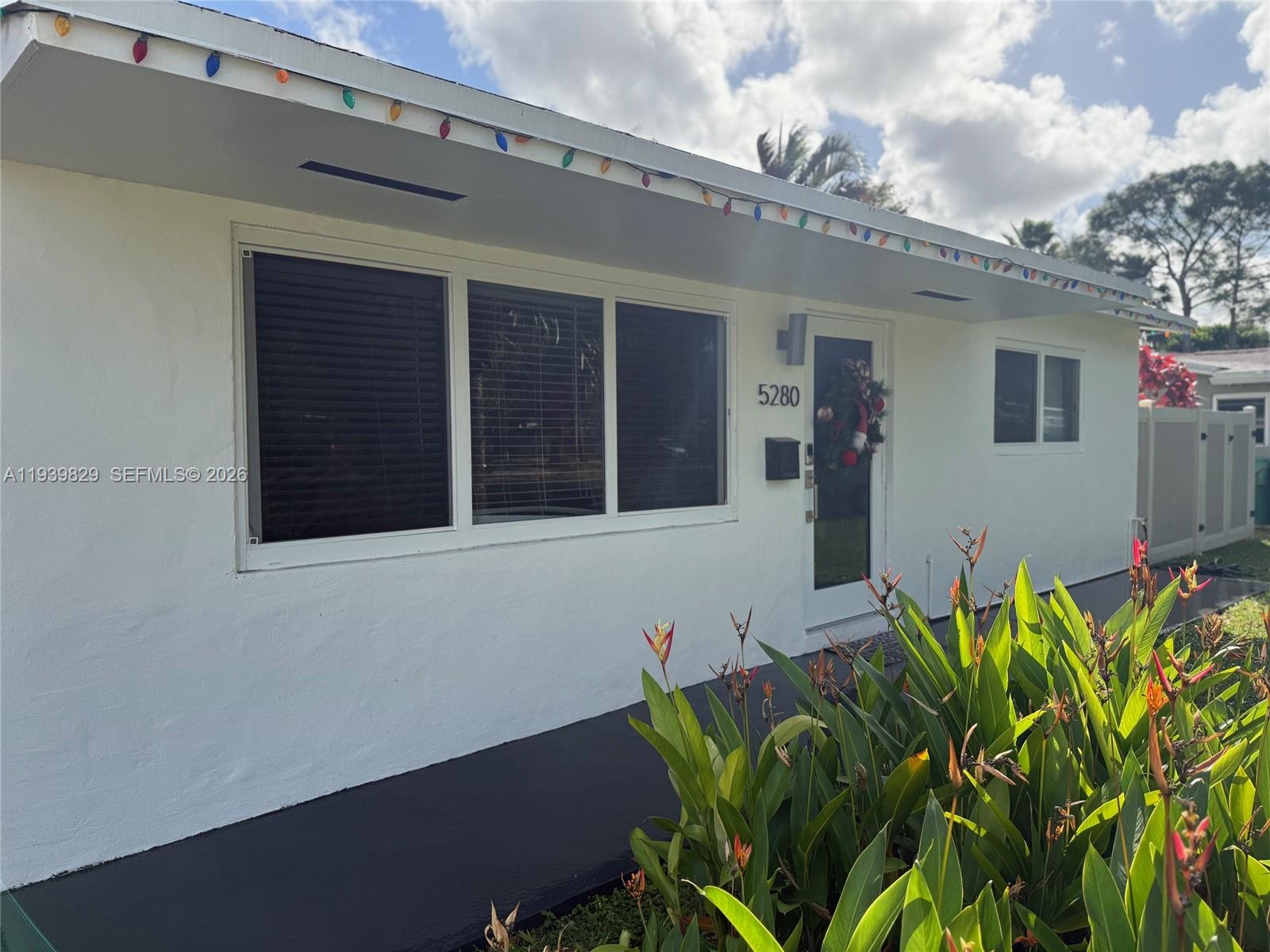 5280 Southwest 92nd Terrace Cooper City, FL 33328 - Photo 10 of 50 a front view of a house with lots of potted plants