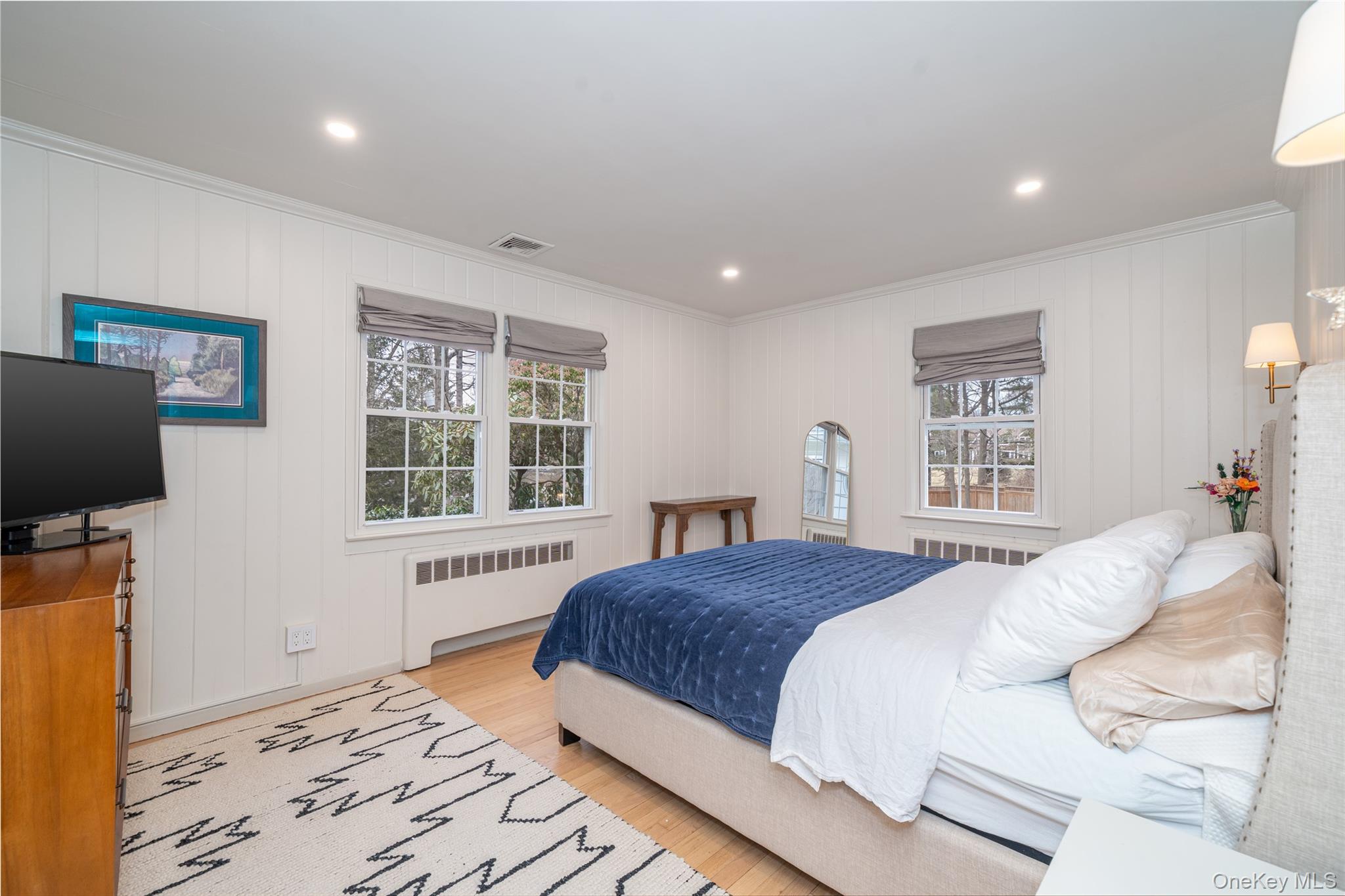 636 Quaker Road Chappaqua, NY 10514 - Photo 18 of 32 a bedroom with a large bed and a flat screen tv