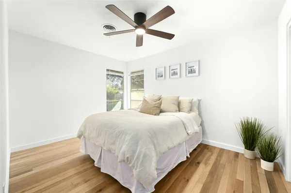 a bed room with a bed and a potted plant