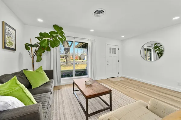 a living room with furniture and a potted plant