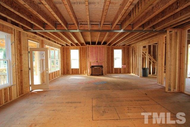 8636 Wapello Lane Raleigh, NC 27613 - Photo 2 of 21 a view of an empty room with a fireplace and a window