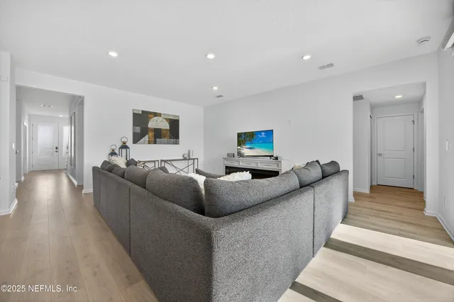 a kitchen with stainless steel appliances kitchen island granite countertop a stove a sink and a refrigerator