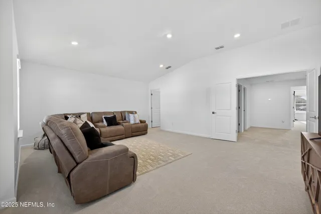 a spacious bathroom with a double vanity sink a mirror and a bathtub
