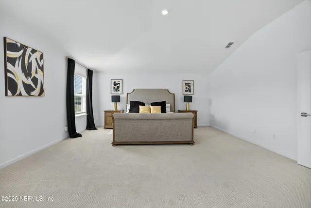 a spacious bathroom with a double vanity sink and mirror