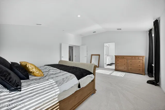 a bedroom with a bed and a night stand