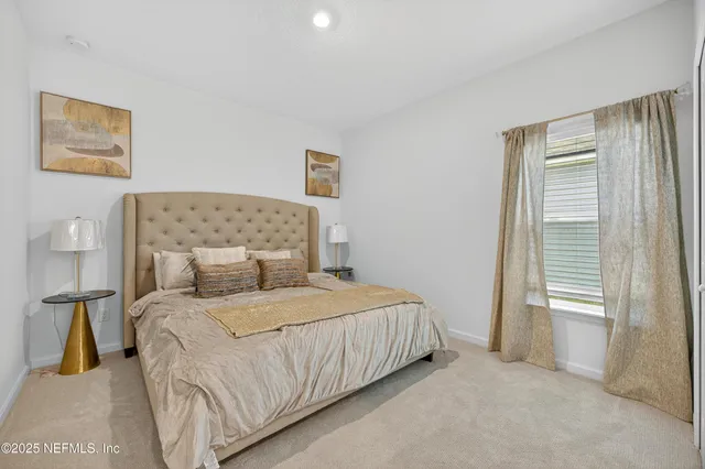 a bedroom with a bed and painting on the wall