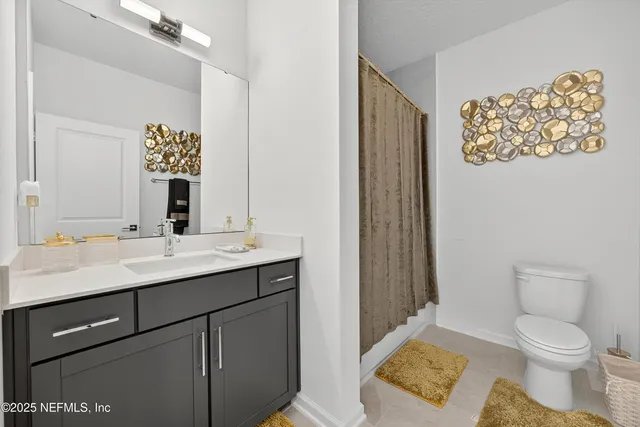 a spacious bedroom with a bed and painting on the wall