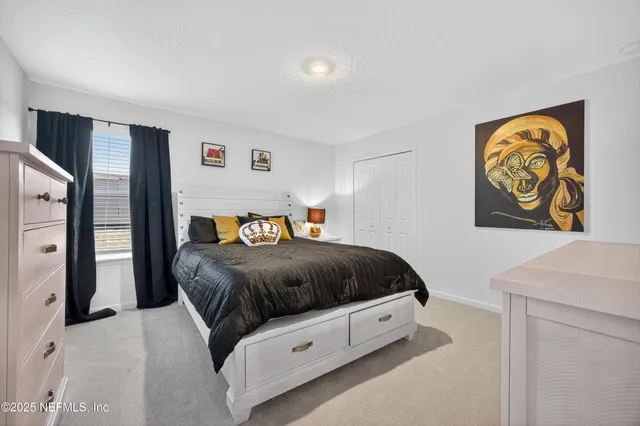a view of a patio with table and chairs under an umbrella