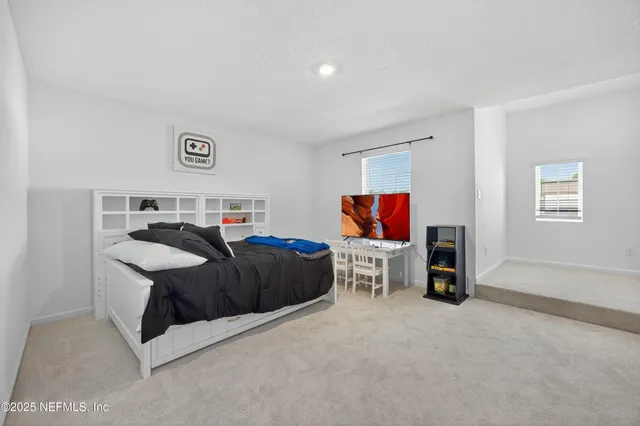 a aerial view of a house with a swimming pool patio and lake view