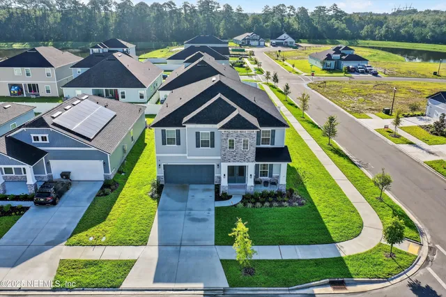a view of a house with backyard and porch