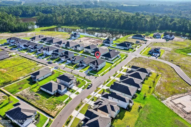 a view of backyard with table and chairs and potted plants