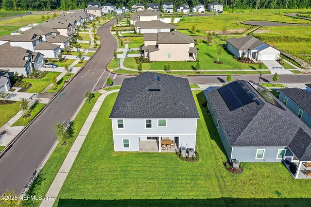 an aerial view of a house with a garden and swimming pool