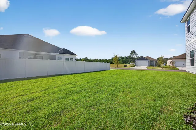 an aerial view of a house with swimming pool and ocean view