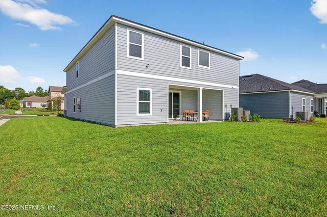 a view of a house with pool and chairs