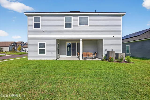 an aerial view of a house with a garden and swimming pool