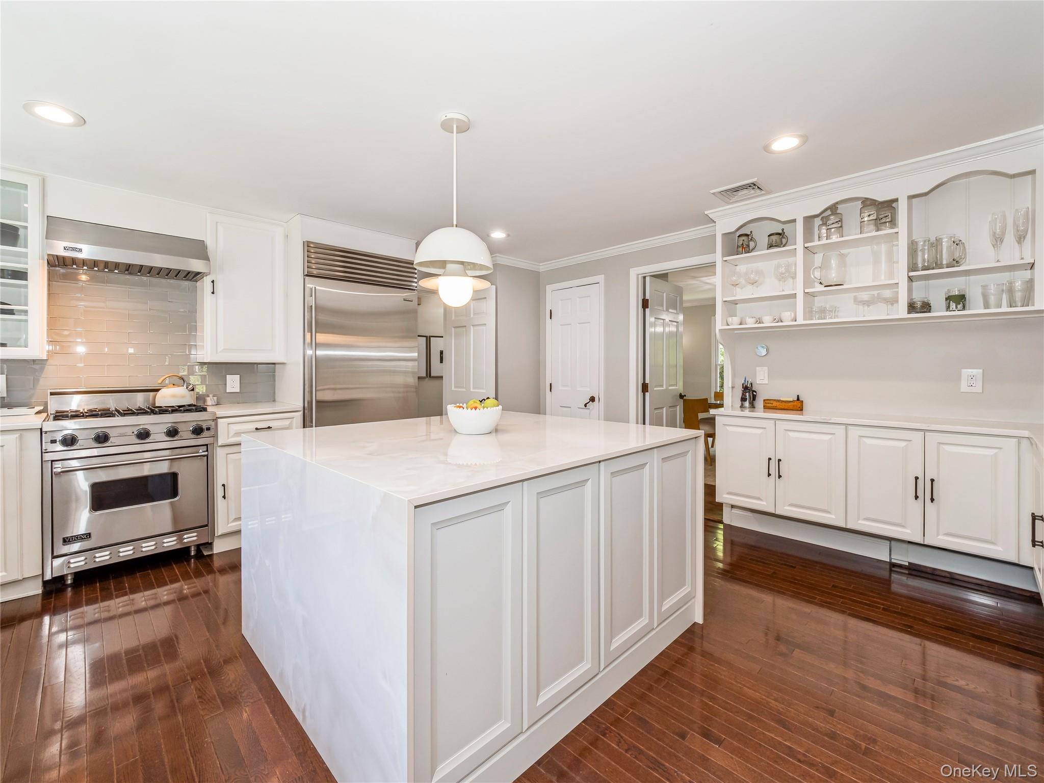 34 Hudson Ridge Garrison, NY 10524 - Photo 13 of 41 a kitchen with kitchen island granite countertop a sink cabinets and wooden floor
