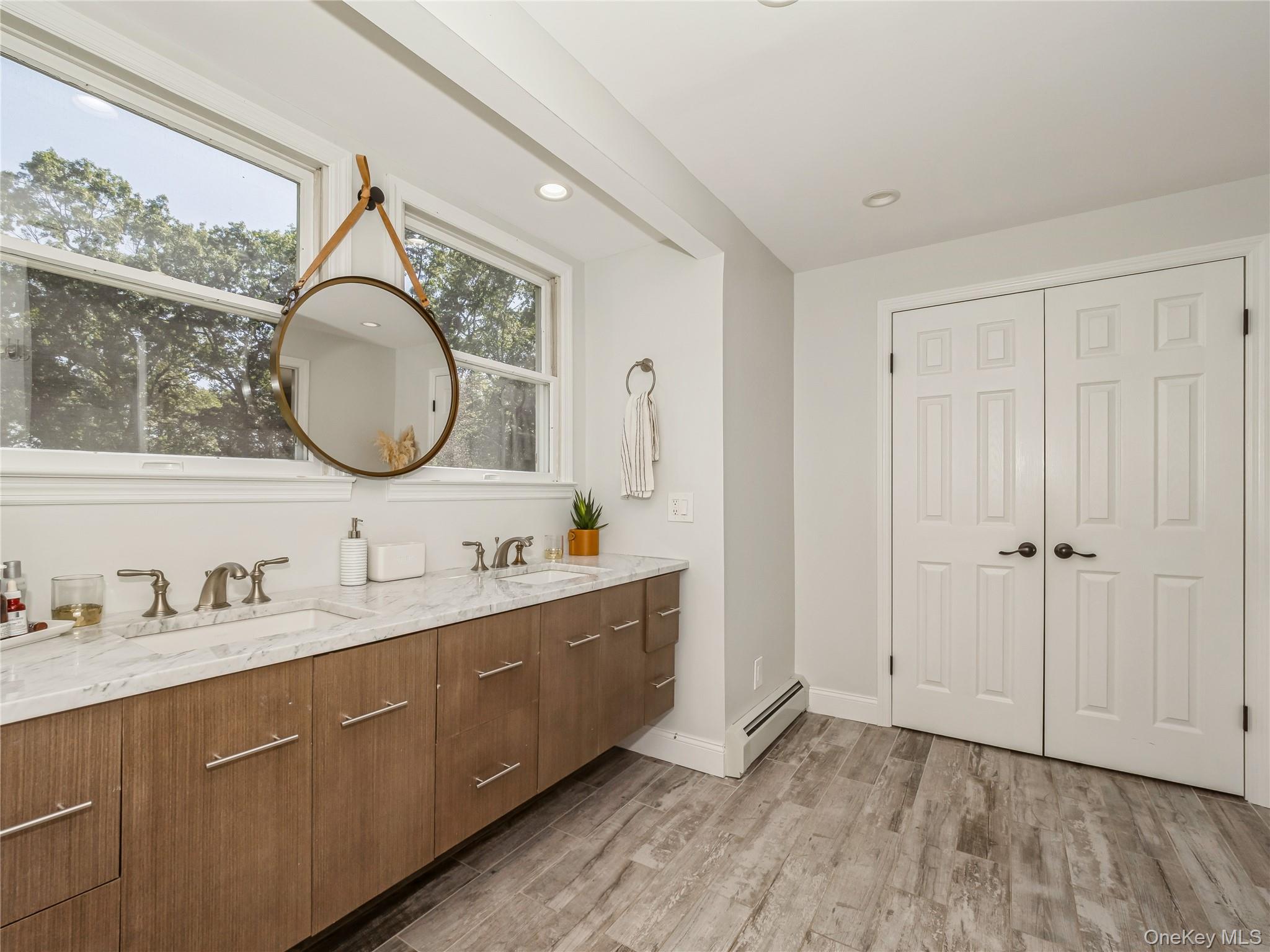 34 Hudson Ridge Garrison, NY 10524 - Photo 29 of 41 a bathroom with a double vanity sink and a mirror