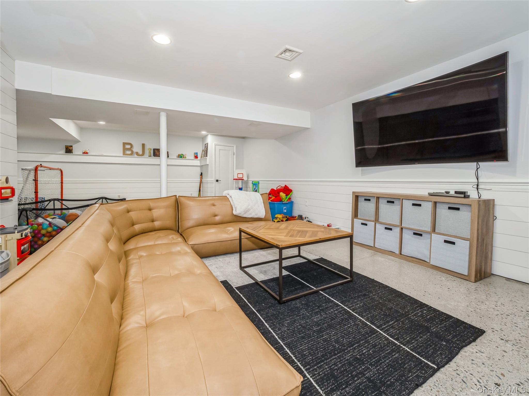 34 Hudson Ridge Garrison, NY 10524 - Photo 33 of 41 a living room with furniture and a flat screen tv