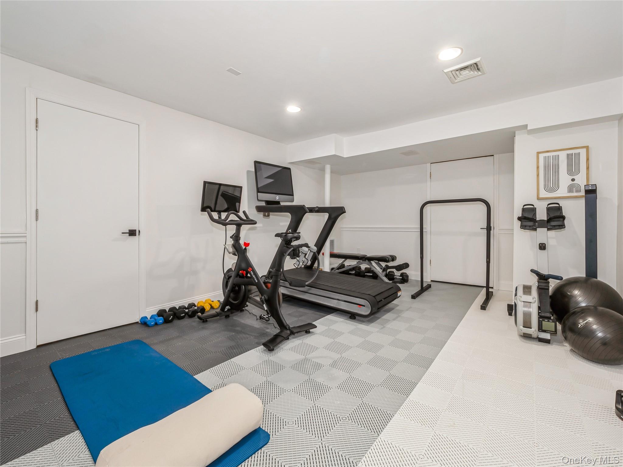 34 Hudson Ridge Garrison, NY 10524 - Photo 34 of 41 a room with gym equipment and a mirror