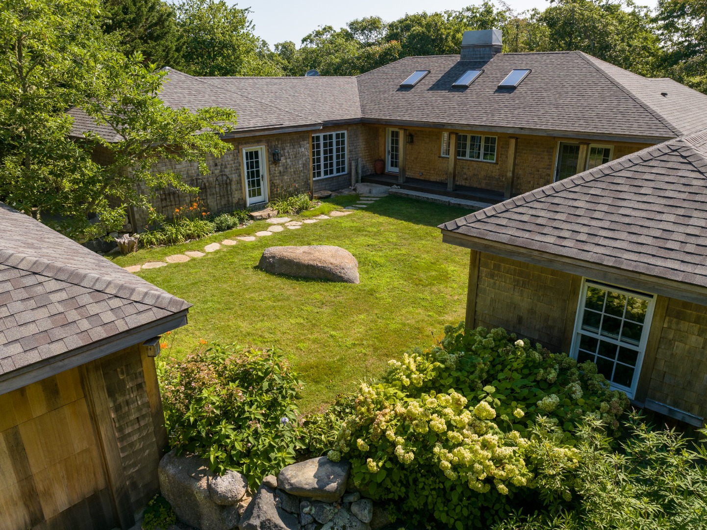a view of a house with table and chairs in patio