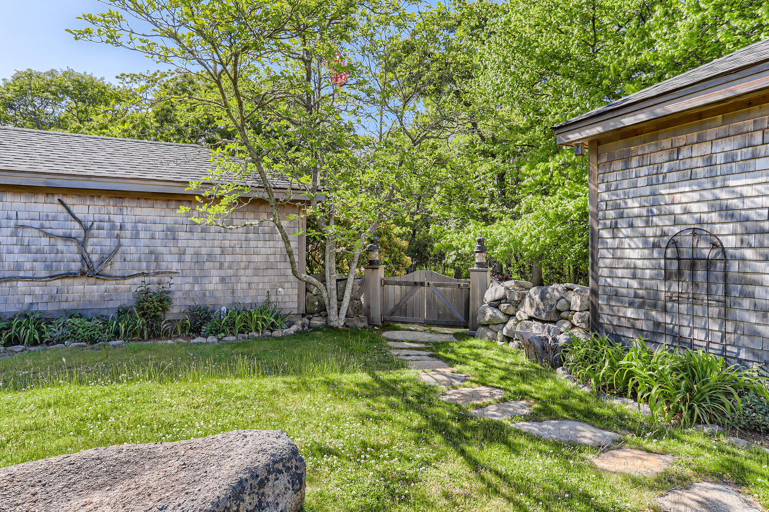 300 N Road Chilmark, MA 02535 - Photo 23 of 69 a view of a backyard with plants and large tree