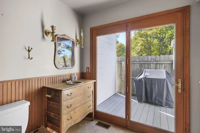 a view of a hallway to a livingroom with furniture