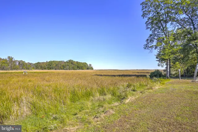 a view of an ocean with a lake in the background