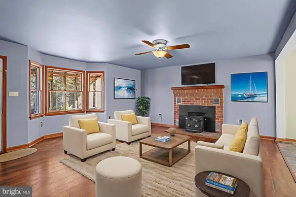 a living room with furniture fireplace and a large window