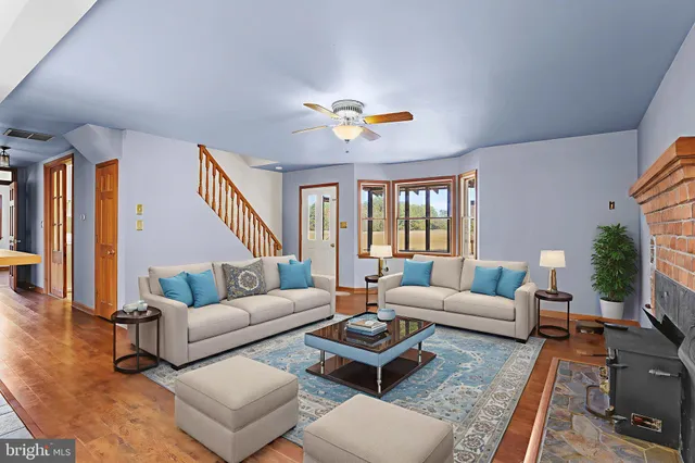 a living room with furniture potted plant and a large window