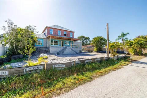 a view of a house with a yard and a garden