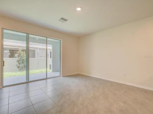an empty room with sliding glass door
