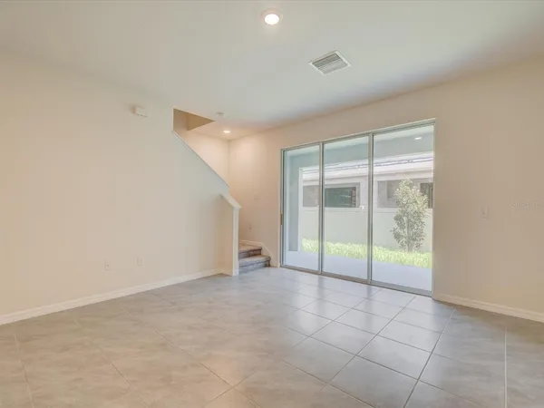 an empty room with sliding glass door and shower
