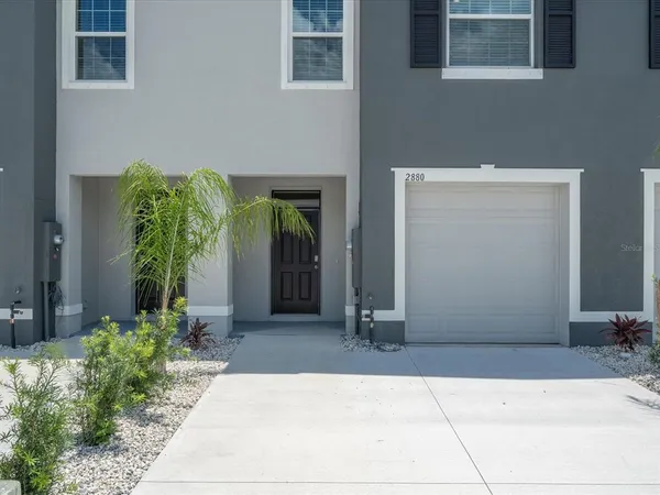 a couple of potted plants in front of door