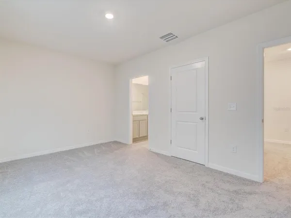 a view of an empty room and a bathroom