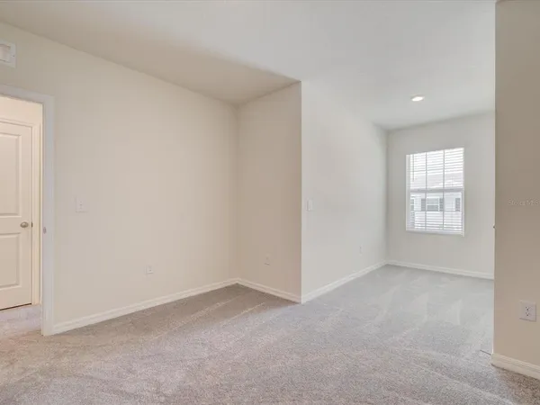 a view of an empty room and a window