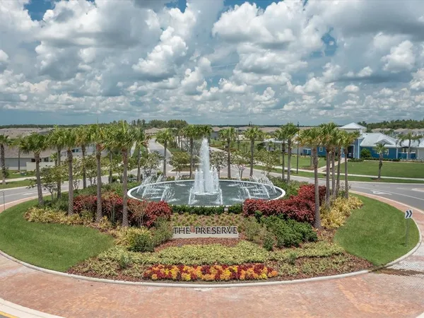a view of a house with a big yard and potted plants