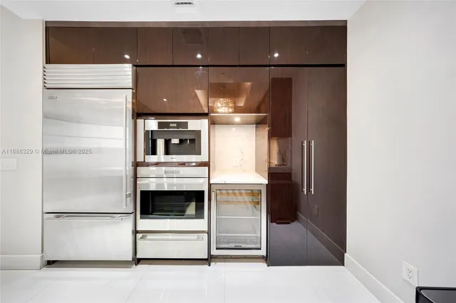 a living room with furniture a chandelier and a fireplace
