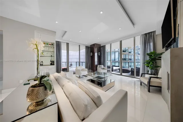 a bedroom with a bed tv and a window