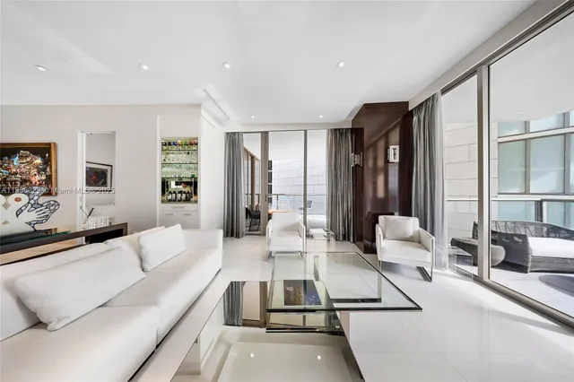 a bedroom with a large bed and a large window