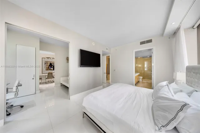 a bathroom with a double vanity sink a mirror and a bathtub